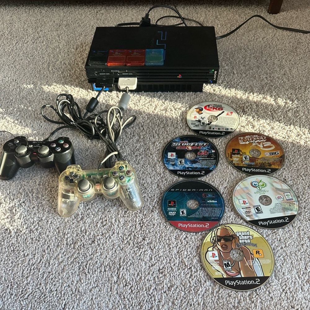 PlayStation 2 Console with Black and Clear Controllers/ 4 memory sticks/6 games